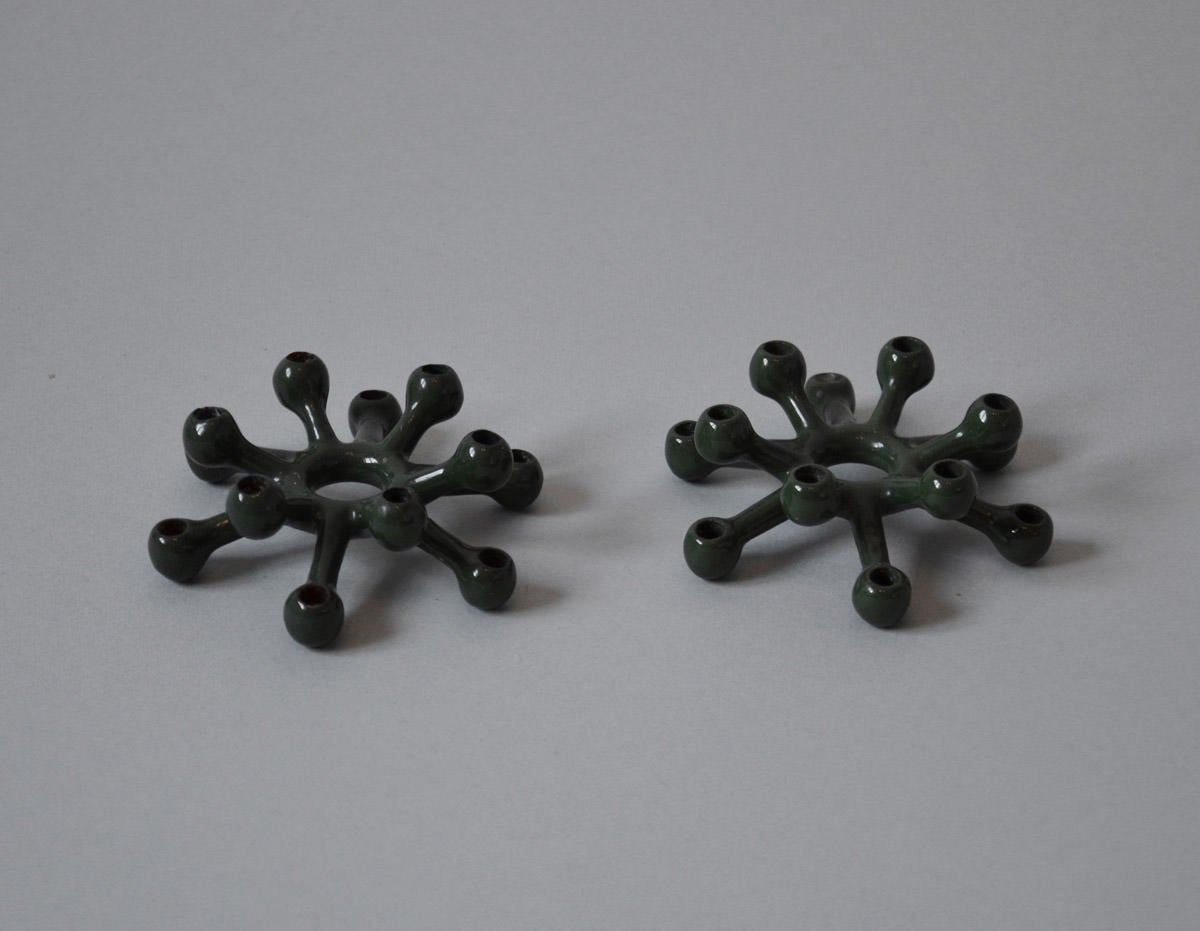 A pair of spider candlesticks in iron cast coated with green enamel. 

We ship this item world wide, please write to contact@apetersen.dk for shipping options and prices.
