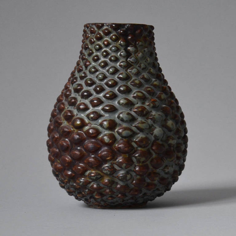 Axel Salto (1889-1961). Early stoneware vase modeled in textured style. Decorated with reddish brown glaze with turquoise green hues. Manufactured at Carl Halier’s workshop in Bredgade, signed Salto, 1930. This vase of particularly high quality