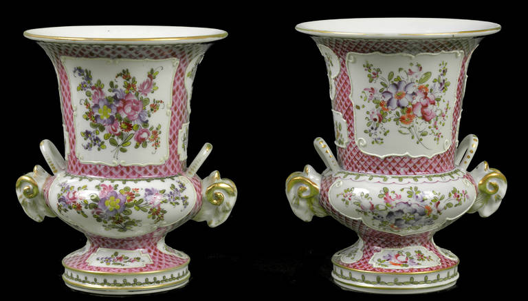 Matching pair porcelain canthare vases
Very much in the Chinese Export style made in Paris by the firm of Edme Samson
Rose-scale ground
White ground panels with raised enamelling framing hand painted colourful bunches of flowers
Flanked by