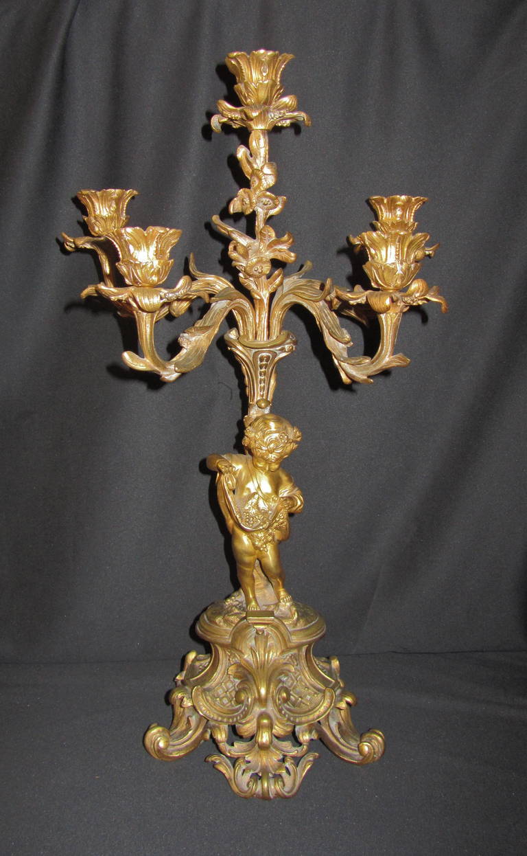 A pair of Napoleon III ormolu five-light figural candelabra.
Cast by Henri Picard, Paris, third quarter of the 19th century.
Each modeled with putti holding nest with bird's eggs and apron with grapes and wine leaves.
Central floral candelabrum
