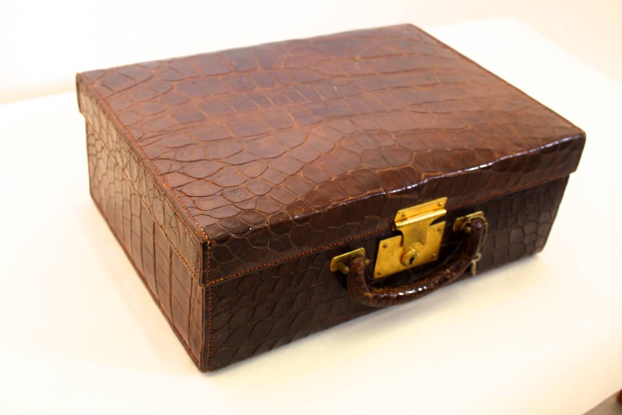 Rare toiletry case with a beautiful interior inside, covered with red leather.
The interior consists of one travel mirror, four bottles of glass, one ink penal and a fire penal and five small cases.

The inside leather has a little fault (take a