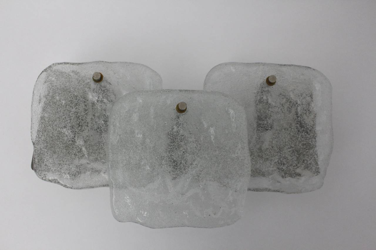 Mid Century Modern vintage glass sconces or wall lights , which were designed by J. T. Kalmar, Vienna, 1960s.
While the sconces or wall lights show an organic sculptural form with ice glass sheets, the nickel plated frame holds the glass sheets with