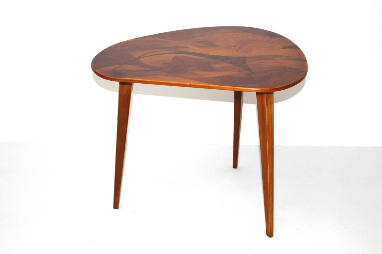 Mid-Century Modern vintage coffee table or sofa table from wood with stunning motifs designed and manufactured in Austria 1950s. The amazing Austrian sofa table shows a base made from of maple tree, while the top was made from pressboard and