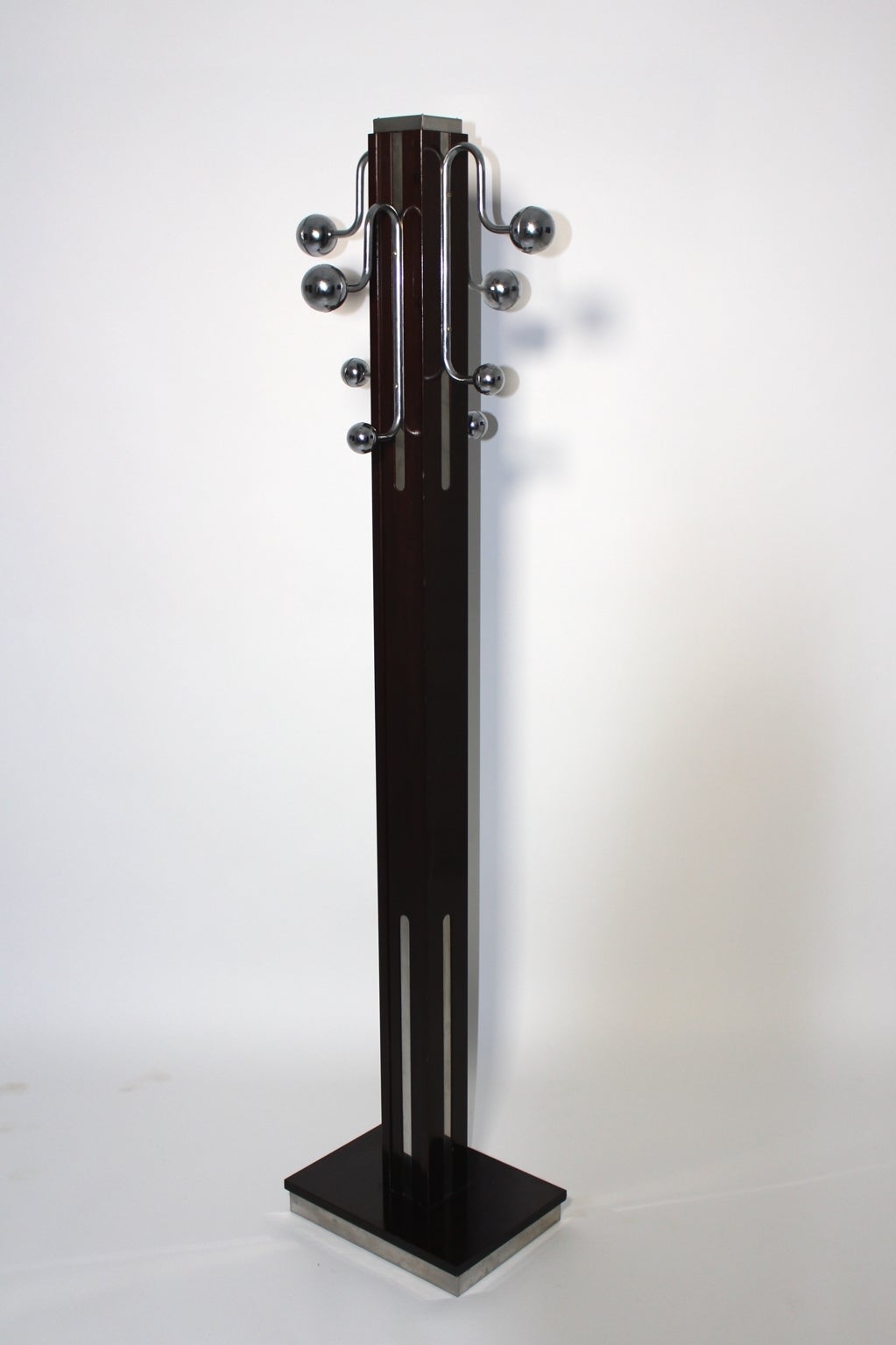 A  vintage rosewood coat stand or coat rack, which was designed by Pierre Cardin attributed, France, 1970s.
A typical chrome band, which covers the edge and the top of the rack, are an important detail and points to the signature of the designer