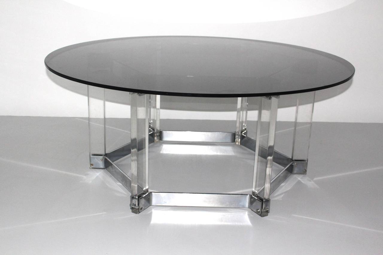 This mid century modern outstanding large sized coffee table or sofa table was designed in the style of Alessandro Albrizzi Italy circa 1968 and shows a hexagonal shape. Also the sofa table is topped with a smoked glass plate.
The vintage condition