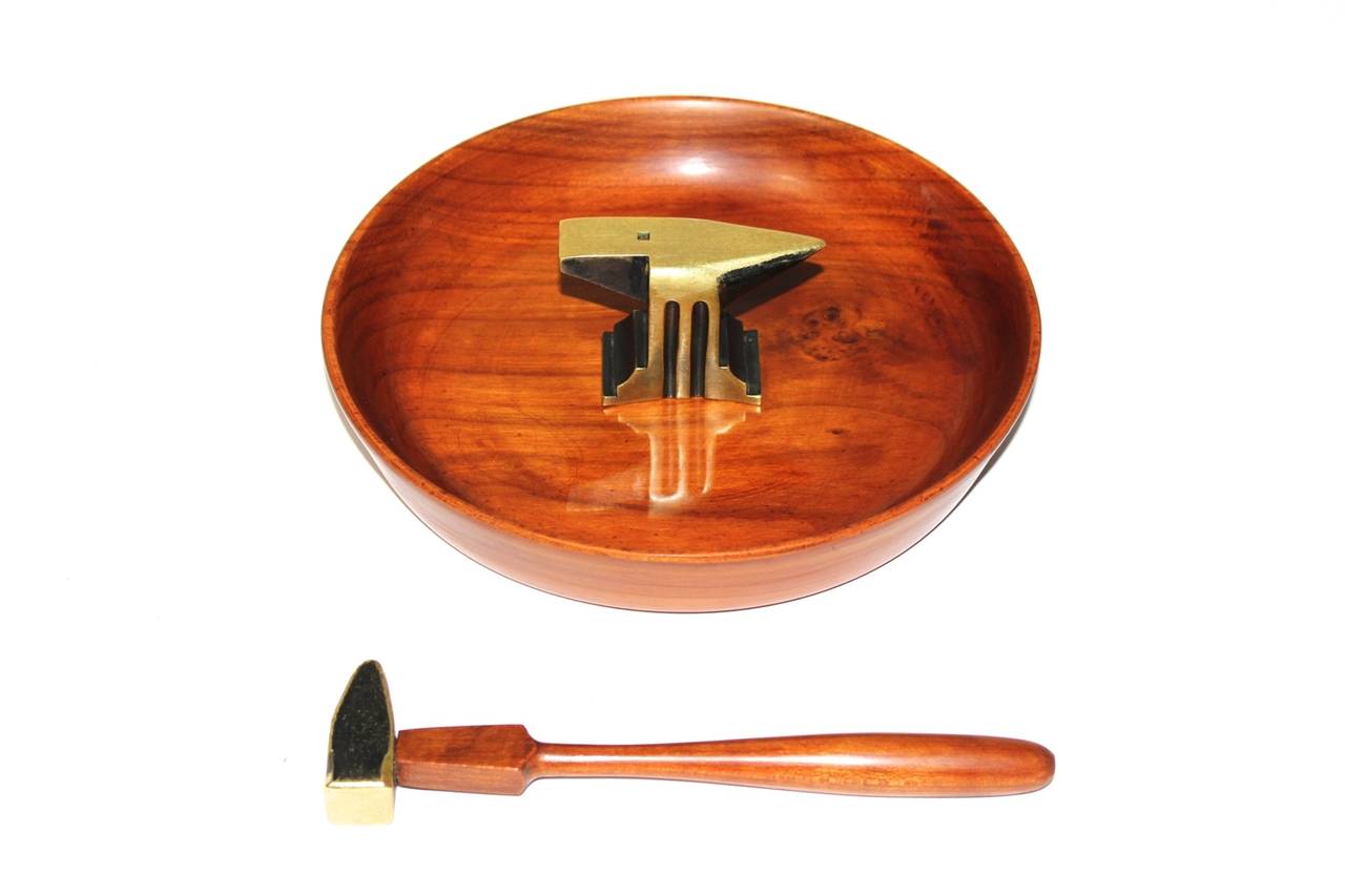 Nutcracker bowl made of cherrywood and bronze, designed and executed by Richard Rohac.

Formerly Richard Rohac worked for Hagenauer till the late 1950s.

In the middle of the bowl there is a Hammer and anvil, which are made of partly black