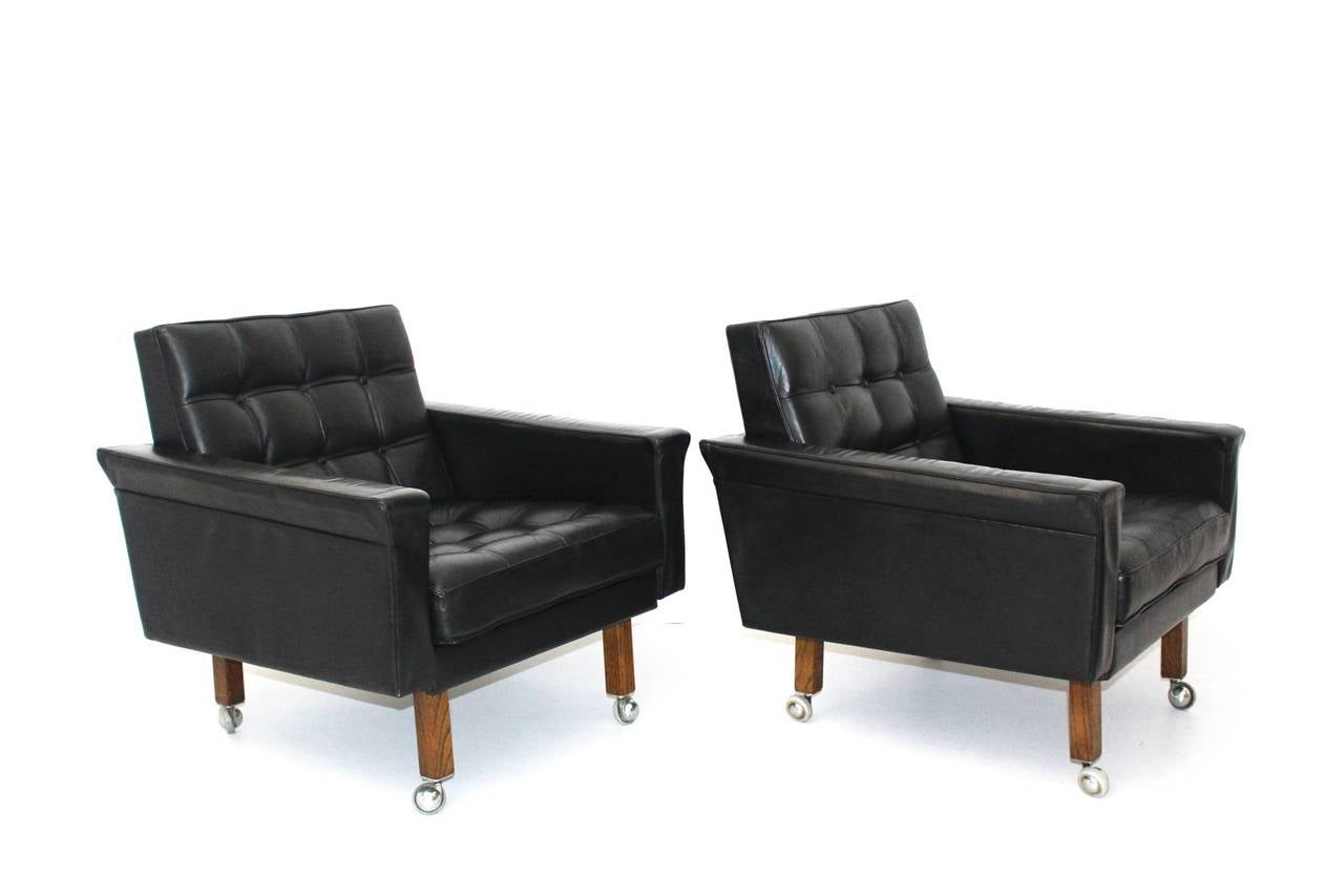Mid Century Modern pair of black leather armchairs designed by Prof. Johannes Spalt and executed by Franz Wittmann, Austria.
Early Johannes Spalt leather armchairs, which features solid oak legs with wheels.
In good original vintage condition with