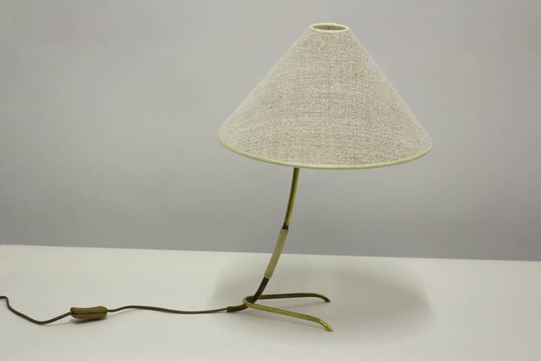 A mid-century modern table lamp by J.T.Kalmar, Vienna, 1960s. The model named Häschen, because the side view looks like a small rabbit.

This table lamp was designed and executed by J. T. Kalmar, Vienna.
The table lamp shows a brass frame with a