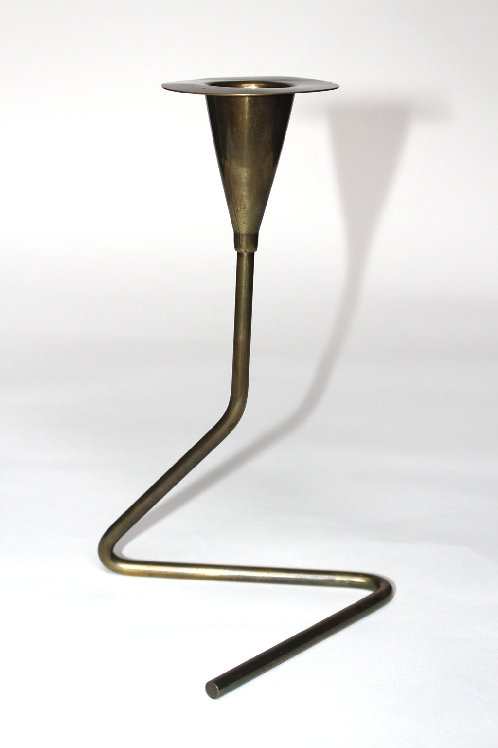 This mid century modern Carl Auböck brass vintage candlestick / candelabras shows a great patina and a beautiful shape.

All measures are approximate.
Width: 12.5 cm
Depth: 13 cm
Height: 21.5 cm

