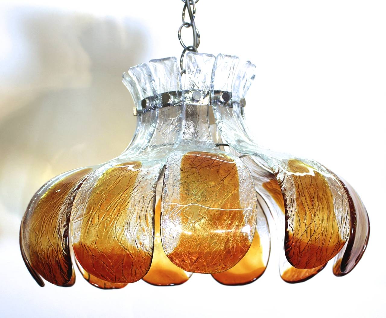 An extraordinary mid century modern vintage chandelier, which was made of thick handmade glass formed like a flower. Designed by Carlo Nason and manufactured by Mazzega, Italy.

Twelve dark yellow and clear glass parts with fittings and one bulb E