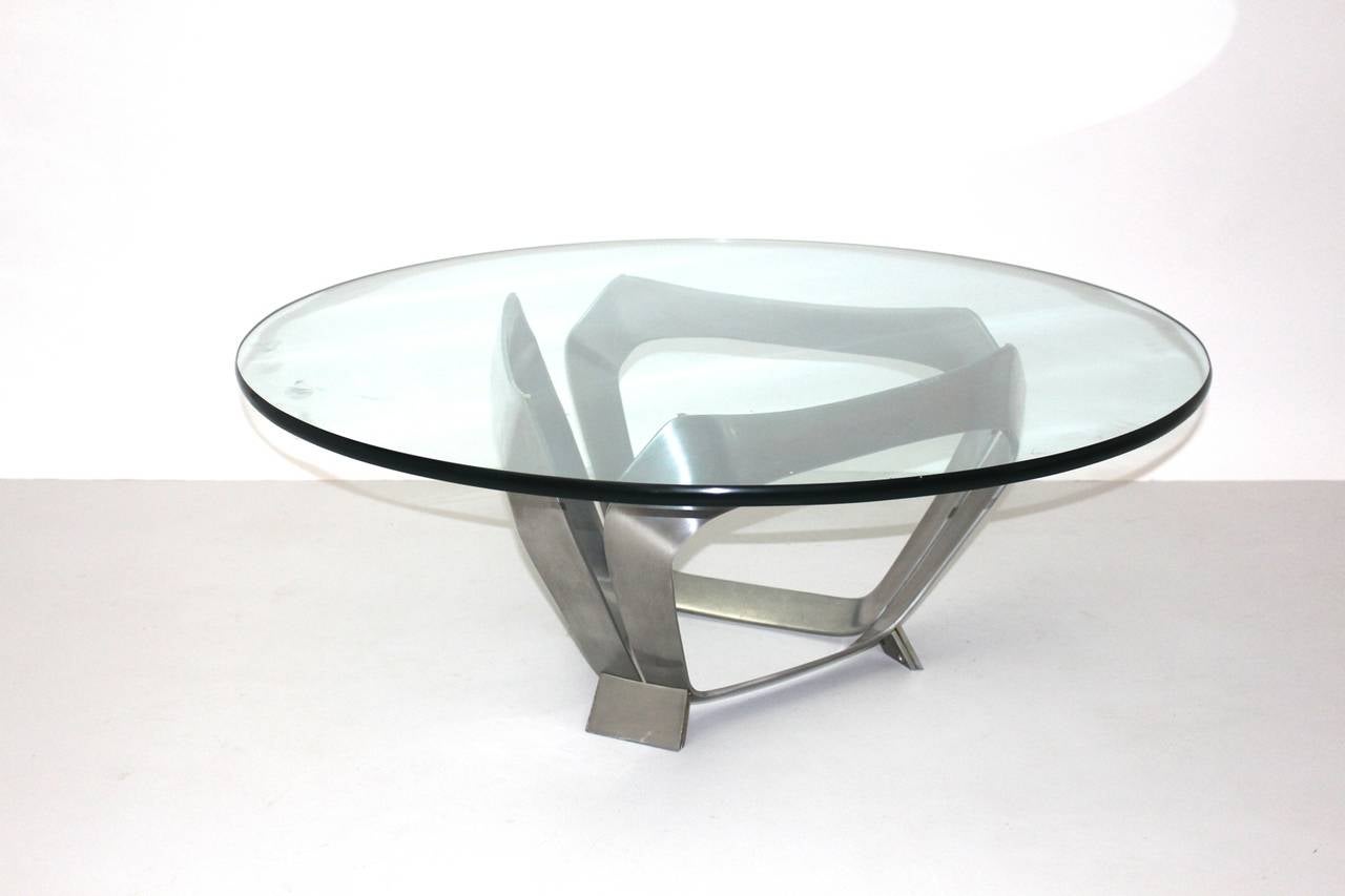 A modernist aluminum glass vintage coffee table, which was designed by Knut Hesterberg for Ronald Schmitt Germany 1970.
While a thick clear glass plate topped the table, the polished aluminum base shows a futuristic shape.
A statement table in very