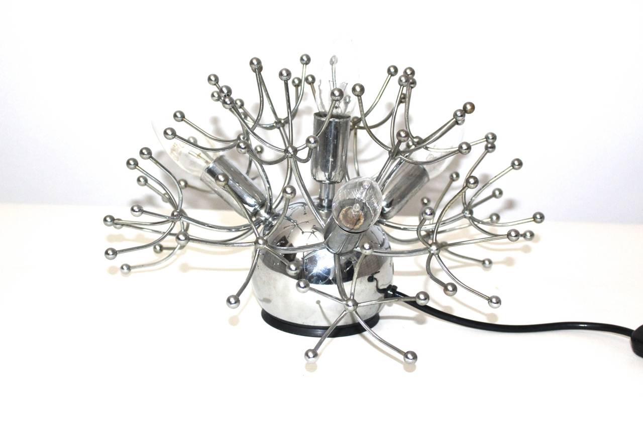 A futuristic chromed table lamp, which was designed and executed by Sciolari circa 1960, Italy.
The table lamp shows four sockets E 14 and an on/off switch.
The vintage condition is very good.
All measures are approximate.