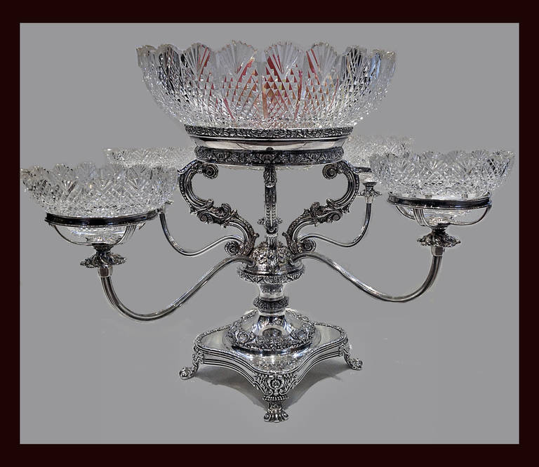 Old Sheffield Epergne, English circa 1830.The square stand on 4 foliage knuckle supports, gadroon foliate rim, base and central section of rich foliage design  and central finial, supporting a large bowl, hob nail design, fan border, 4 reeded arms