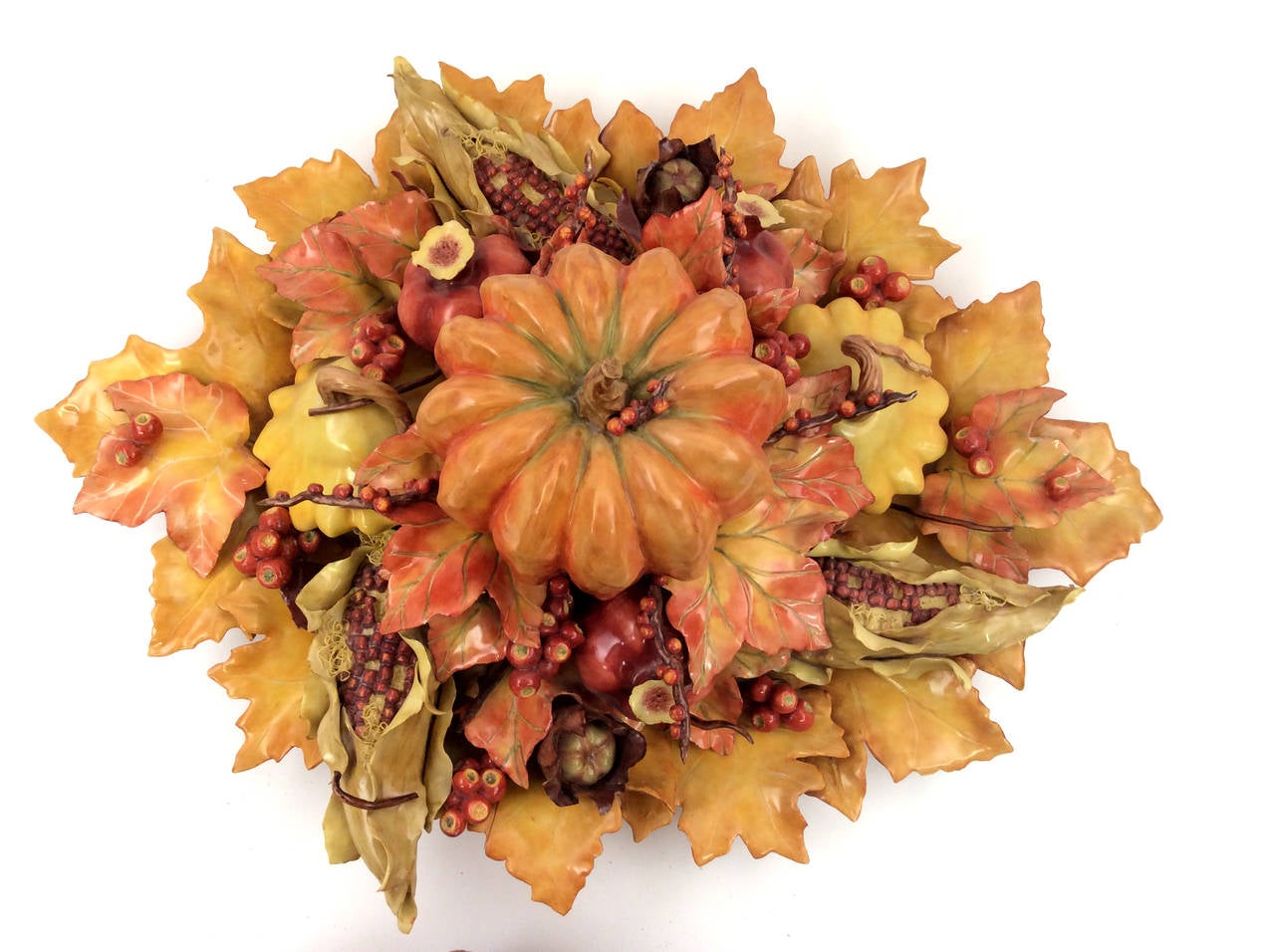 This centerpiece is one of Katherine's most treasured pieces, decorated with rich autumn leaves and harvest including maize, pattypan squash pomegranates and husked cherries. This piece is a beautiful centerpiece for the whole fall season. This is a