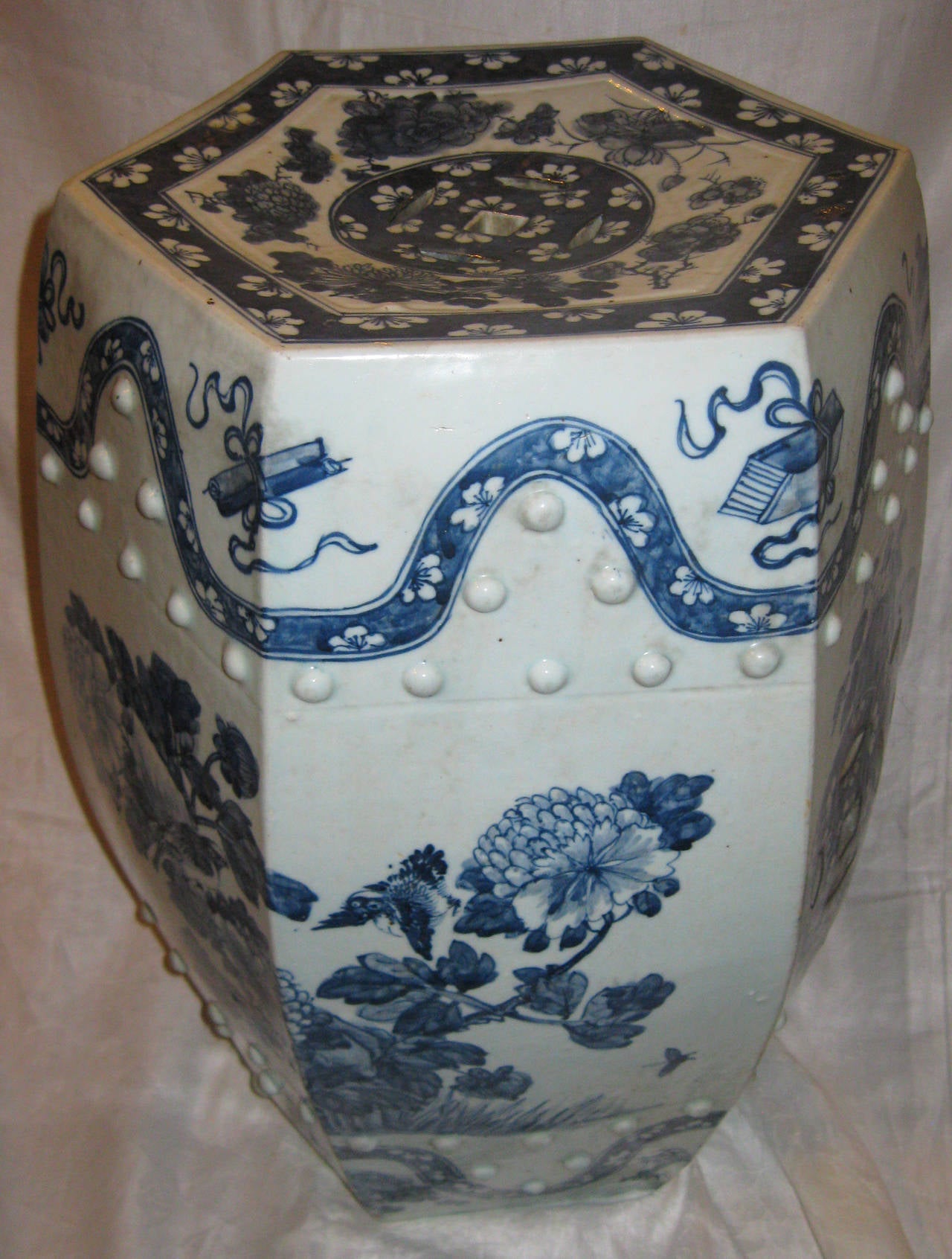 Sechseckiger chinesischer Gartenstuhl im Nanking-Stil aus blau-weiß glasiertem Porzellan. Zu den Merkmalen gehören eine durchbrochene Oberseite und Seiten, geformte Reliefpunkte und eine sehr raffinierte Ausführung des Blumenmusters, ein großer