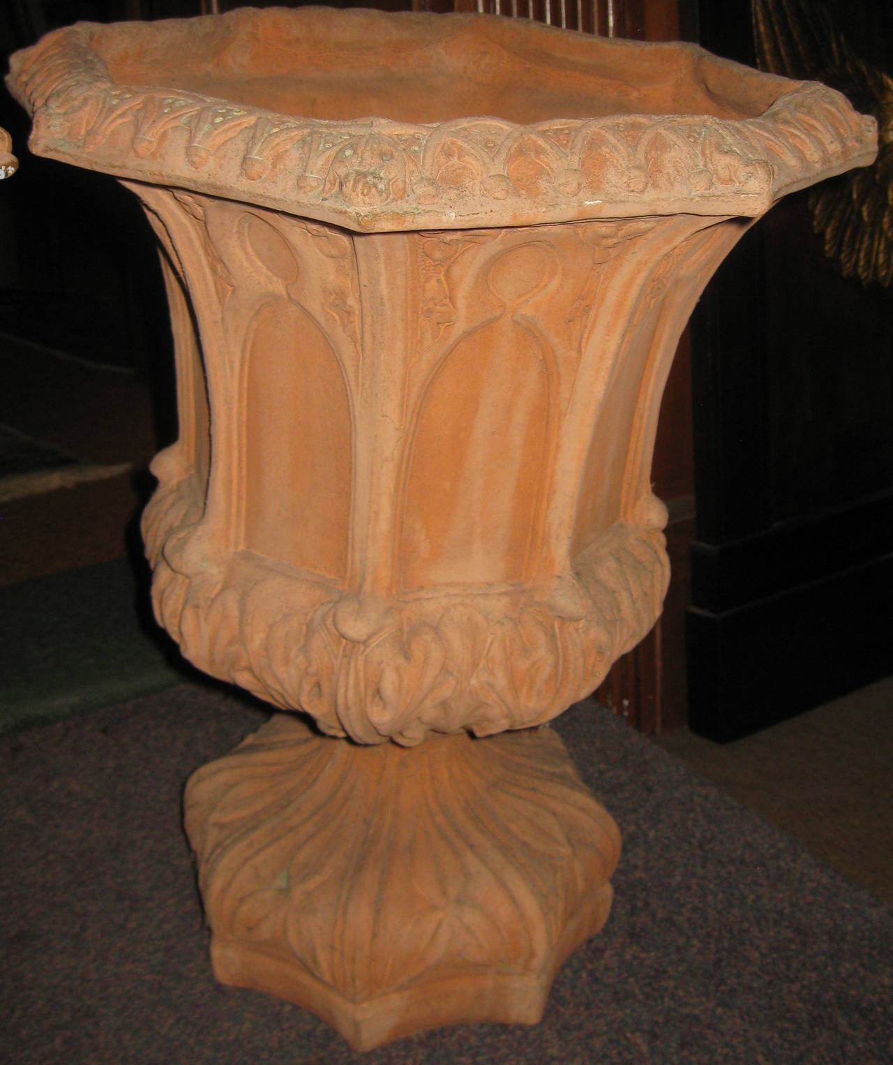 Designer pair of Italian octagonal shaped heavy terracotta, mid 20th c. pedestal garden urns. Features include a raised extreme Gothic design with lots of detail. They are a nice size, fitting an 8