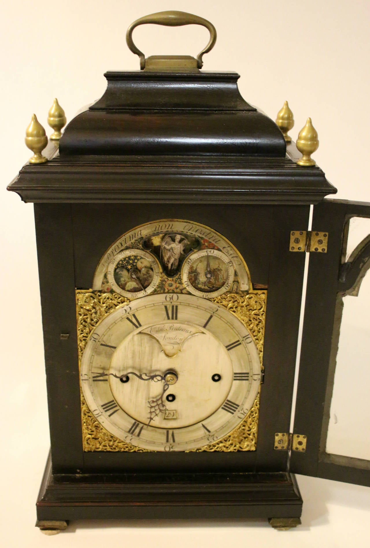 Mid-18th century ebonized bracket clock by Edmund Prideaux, who worked in London between 1743 and 1790 and is particularly respected for the Fine cylinder watches that bear his name.
Inverted bell top centered by a handle over circular and shaped
