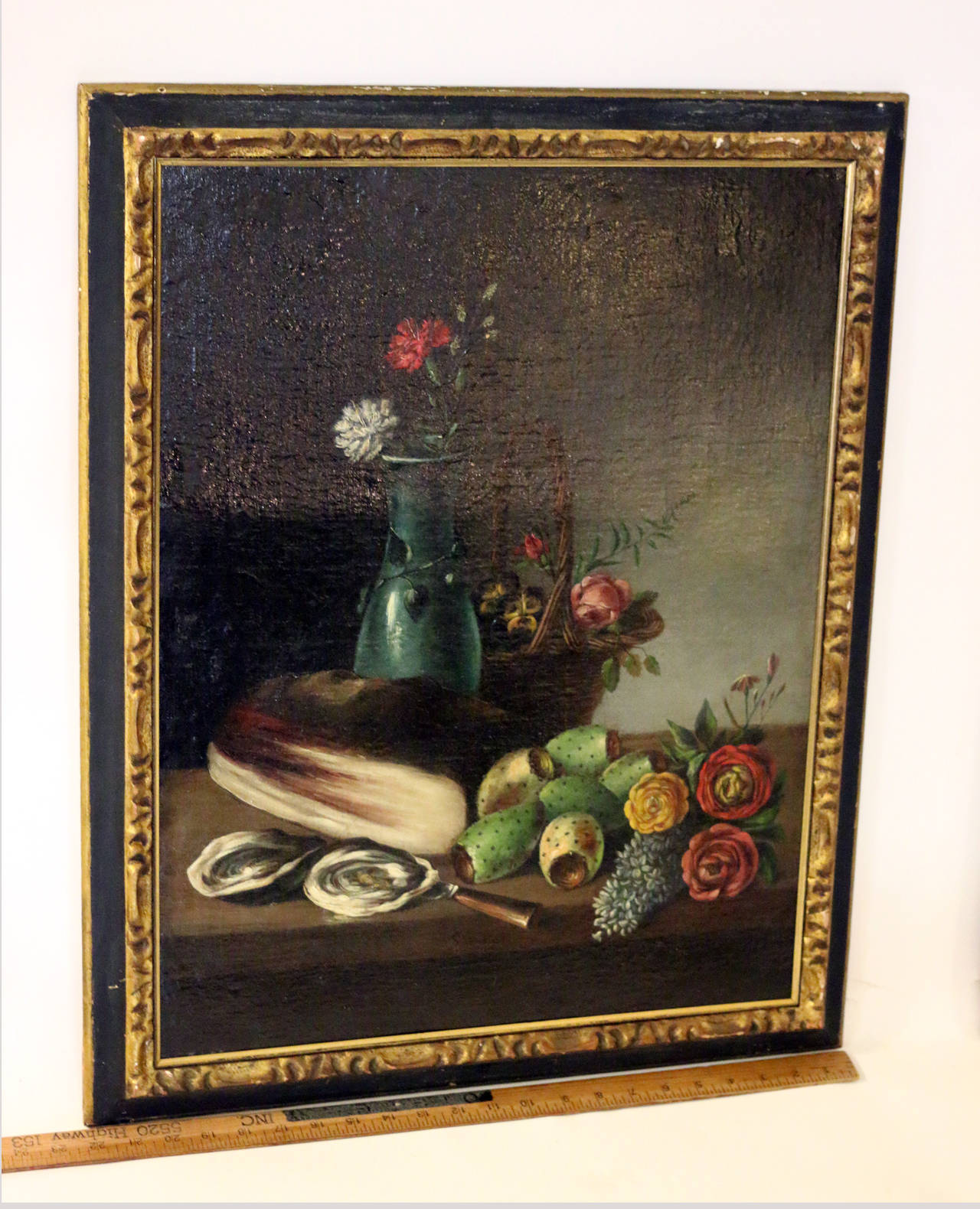 Still life pair of unusual subject matter; one featuring various fish, flowers, fruit and a large basket. The other a vase of flowers including lilac, roses, pansies and carnations with prickly pears, oysters and a small basket. Oil on canvas,