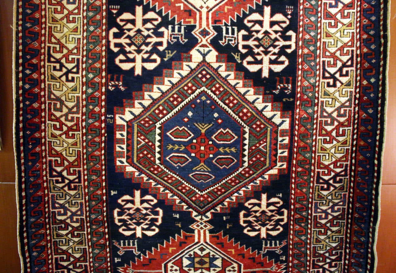 19th century carpet handwoven by the tribes of Caucasus. The featuring floral and geometric patterns with three hexagon within hexagon medallions. Stunning color and incredible detail.
See measurements below.