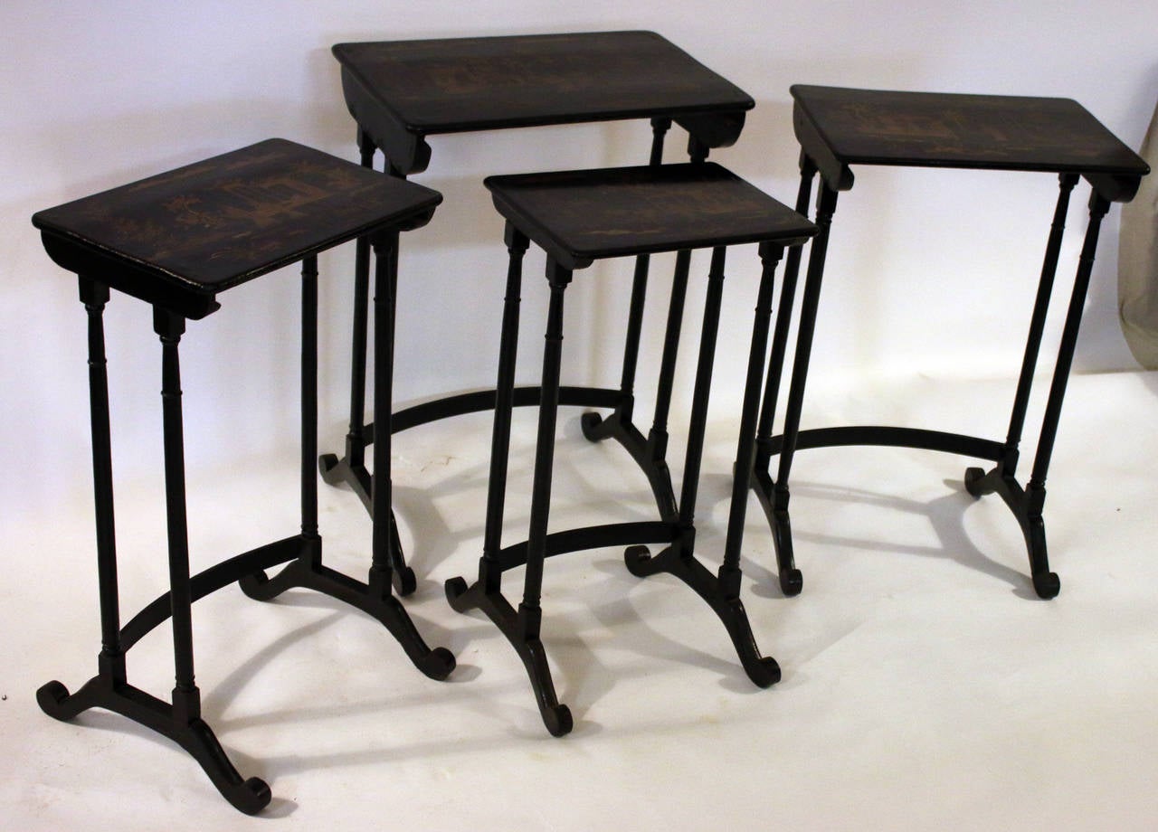 Early 1800's set of four black lacquer Japanned stack tables. Features include
chinoiserie gold painted accents with much detail and elegant turned legs. Note the bowed bottom wrung on each table. The measurement below is for the largest table