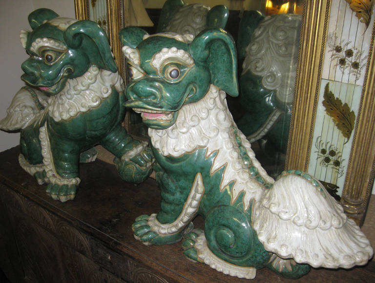 Extraordinary pair of fine glazed porcelain Foo dogs came to us out of an estate here in Savannah, Georgia, belonging to an old general that long ago brought them from Thailand. Used to guard the entryway to temples and homes of the very rich, they