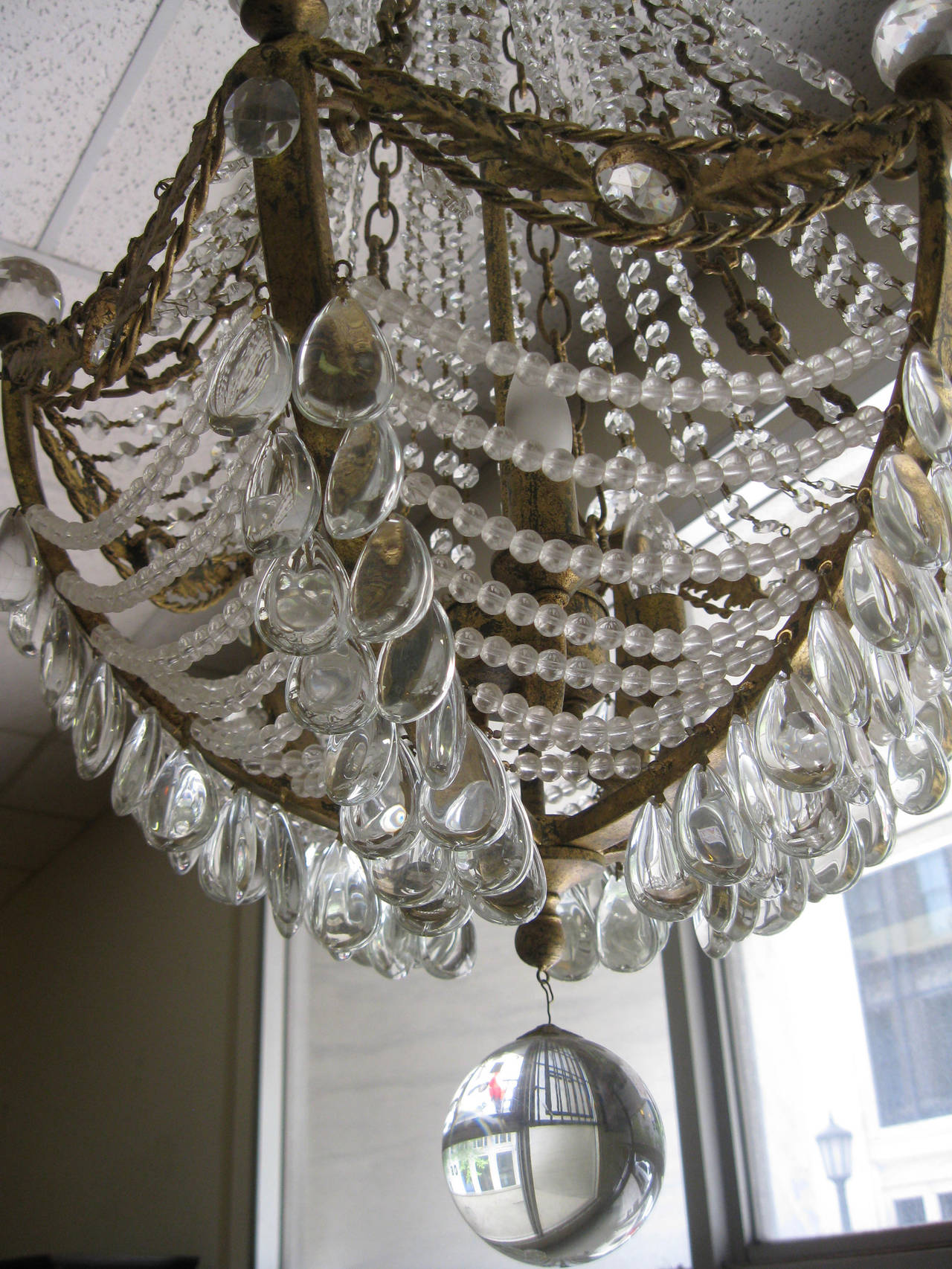 Original waterfall chandelier from the old interior of the Russian Tea room in New York City. Featuring lovely doré bronze and crystal, this gorgeous chandelier, circa 1920s, has an elegant elongated shape with highlights including five styles of