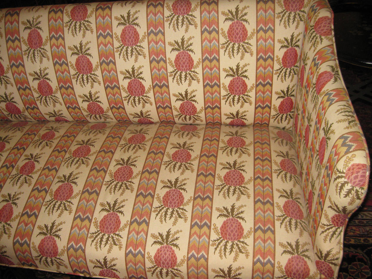 Hepplewhite sofa dating from circa 1775-1785, newly reupholstered in Scalamandre double cloth fabric that features a welcoming pineapple motif. The curvilinear mahogany and well balanced shape are classic Hepplewhite. Tapered mahogany legs.
