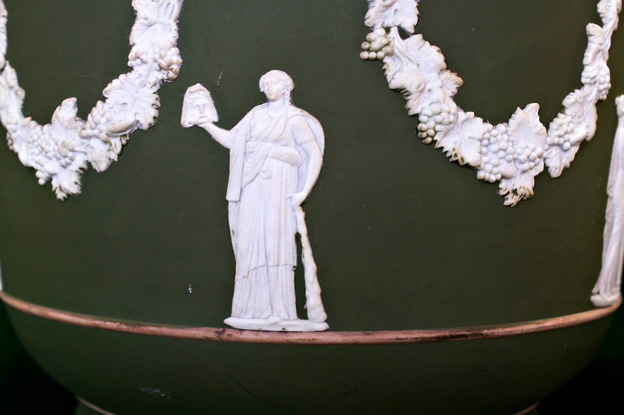 Large size green Jasperware jardinière by Wedgwood. This lovely piece features beautiful white decoration done in high relief on green color background. The Jasper dip is done in the form of elegant clusters of grapes and vines supported on