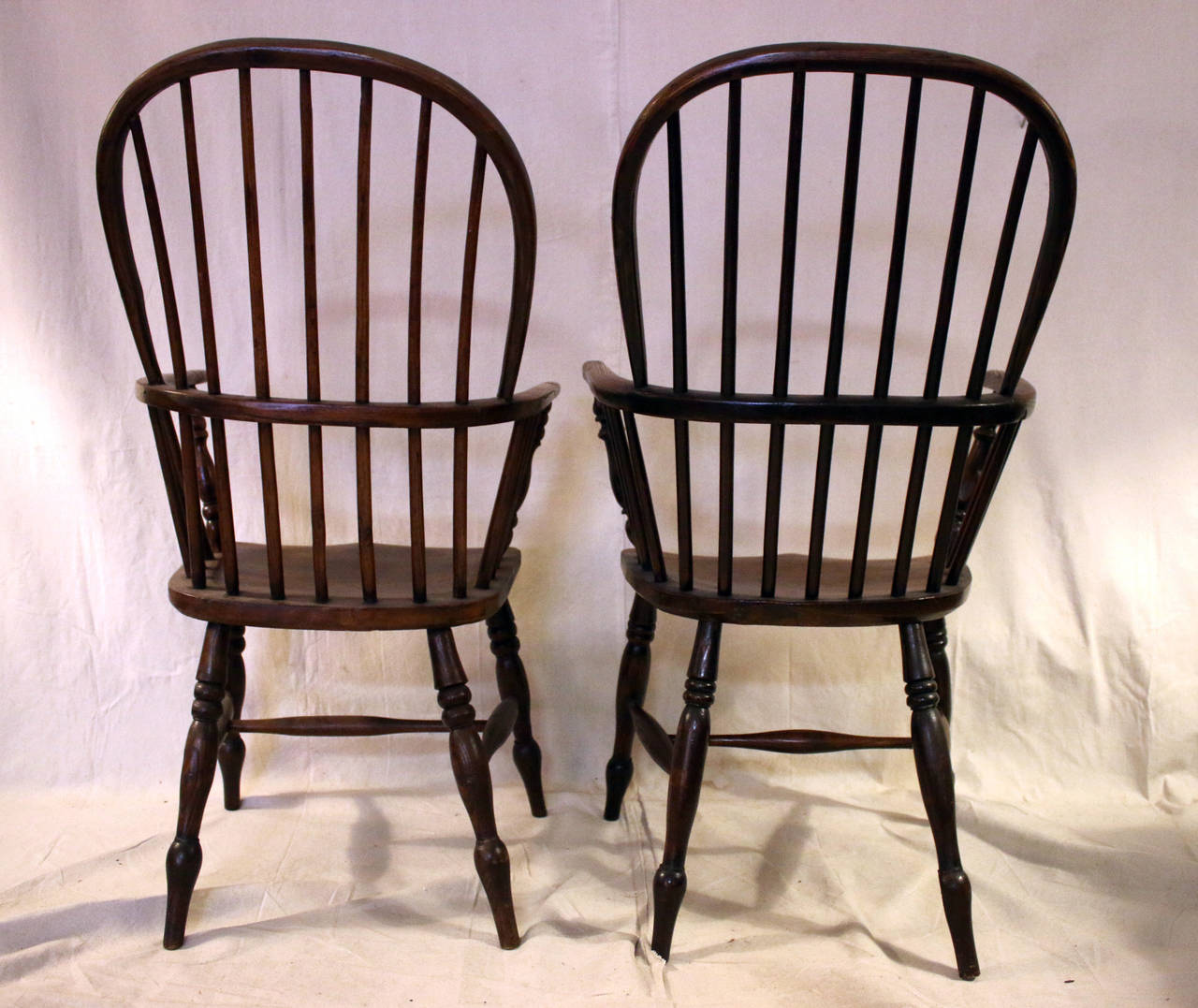 An assembled set of eight high backed, comb back Windsor’s featuring curved arms and splayed turned legs joined by stretchers. All have seven spindles at top and 15 below. There are a couple of very subtle differences in the turnings of the