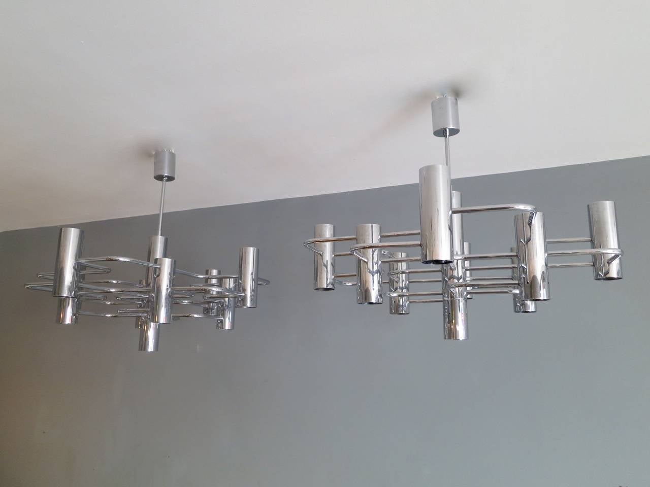 A pair of modernist chrome chandeliers by Italian designer Sciolari for Belgian manufacturer Boulanger. Having nine-light fittings each on a geometric frame.