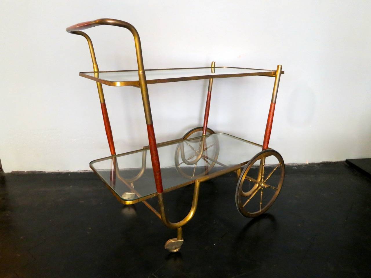 A brass and Rosewood two tired trolly. Larger than most of its era, with original glass tops.