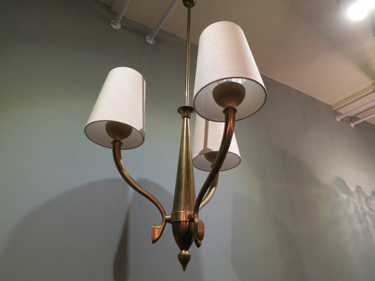 A compact 3 arm brass chandelier, with new shades (the originals are available) 
very much in the style of Ulrich