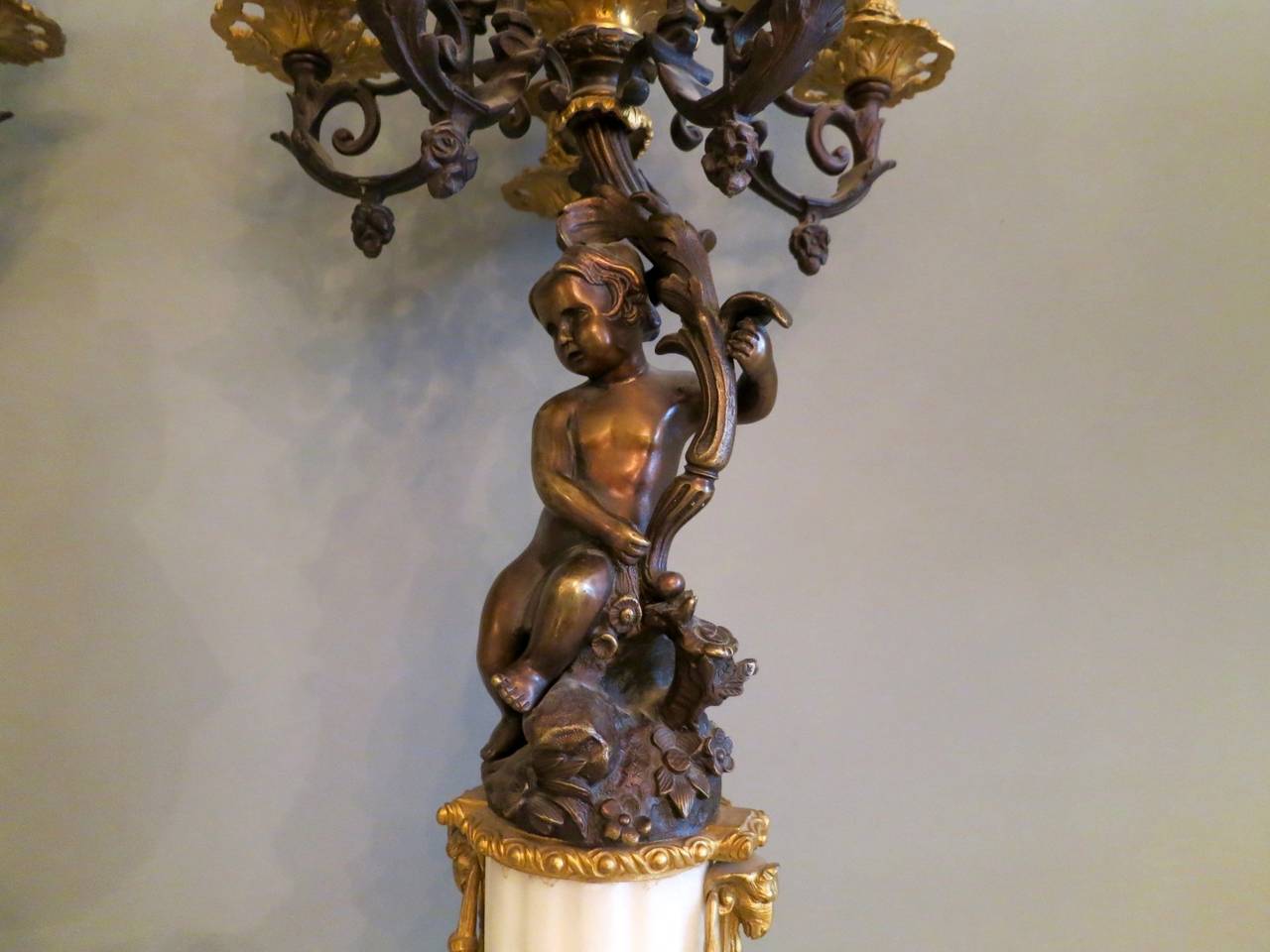 A good quality pair of late 19th century six-arm candelabras in bronze and ormolu with cherubs. Original gilt and patina throughout.