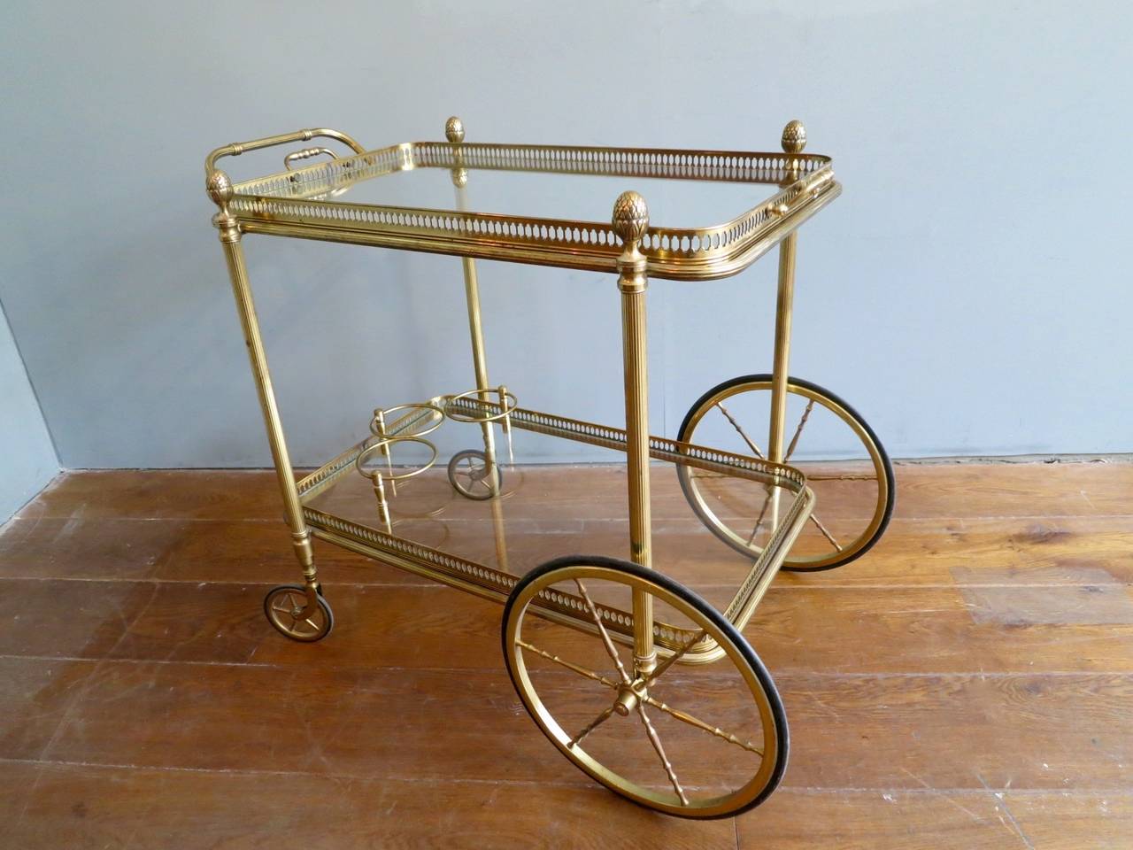 A fine quality French Brass Bar cart, with two removable trays, and acorn finial decoration.