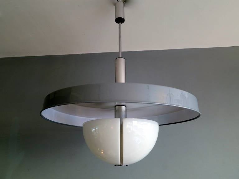 A large pendant light with grey and white circular metal shade, white acrylic diffuser and chrome fittings. Signed Stilnovo. Another is also available with white shade.