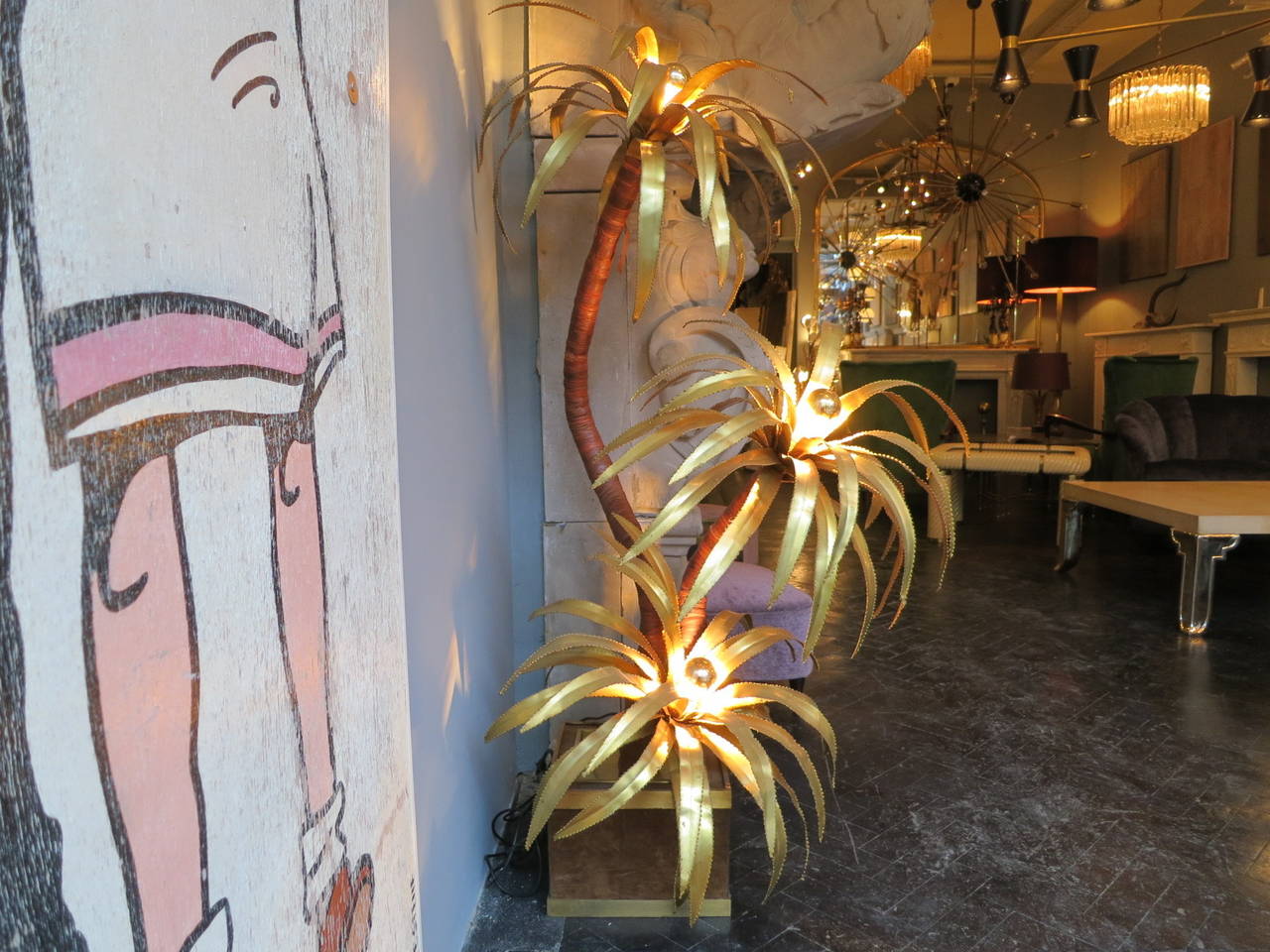 A large three-headed brass palm floor lamp. With suede and brass base, attributed to Maison Jansen, Paris.