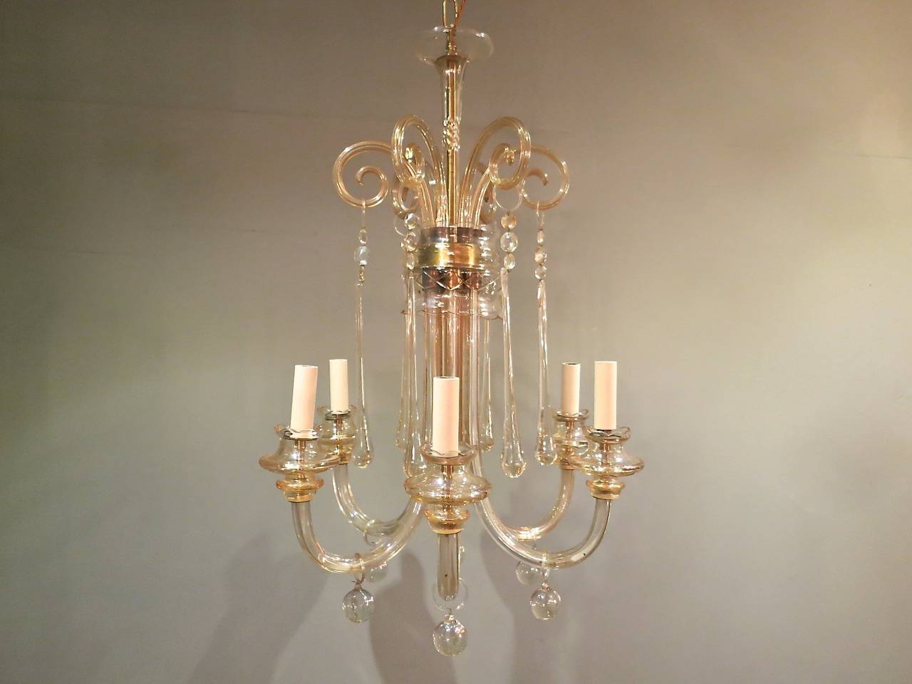 A Mid-Century Murano chandelier in Champagne colored glass, with scrolls supporting long teardrops and six arms. Italy.