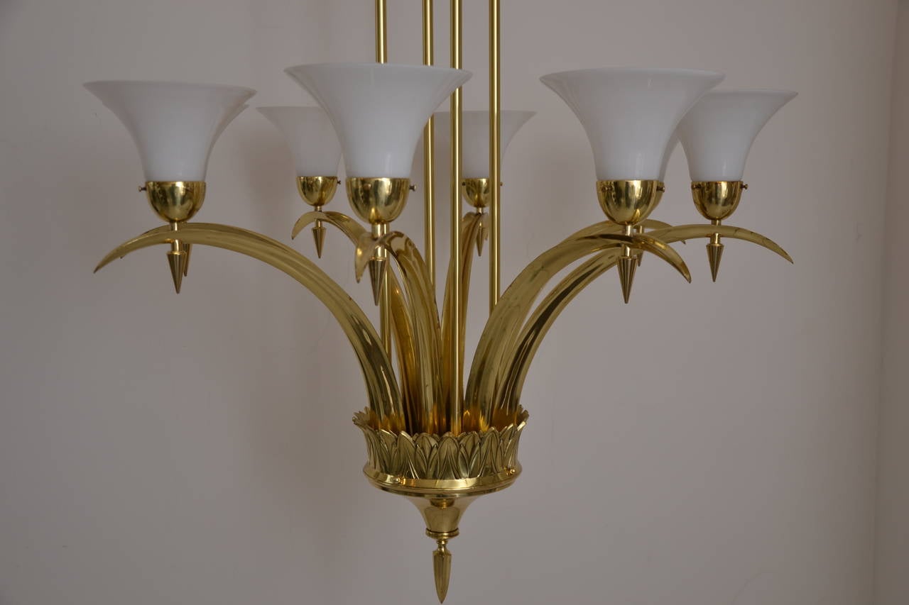 Very big massive chandelier with white glass shades
polished and stove enameled
massive cast parts.