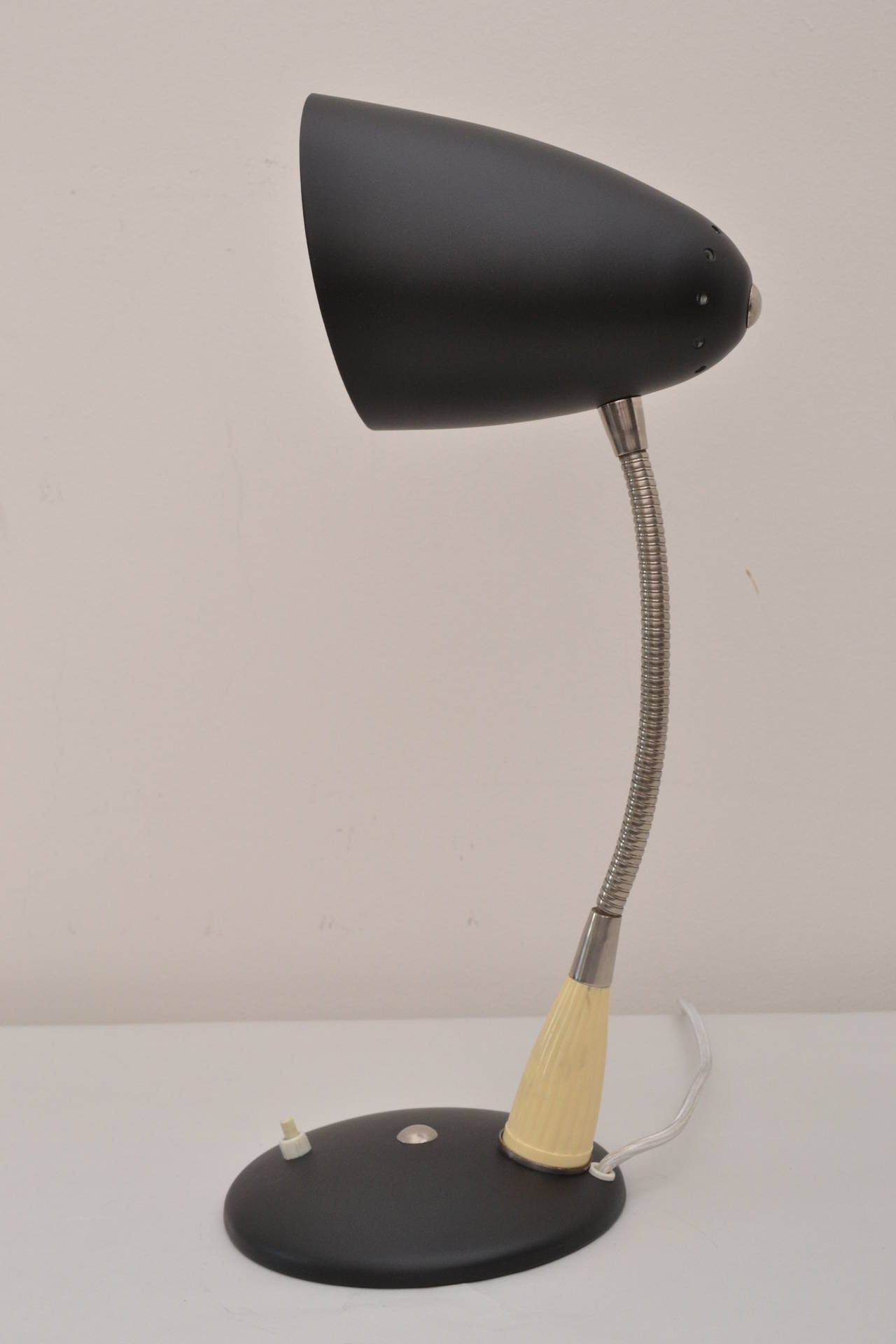 Adjustable table lamp, circa 1950 
Black lacquered