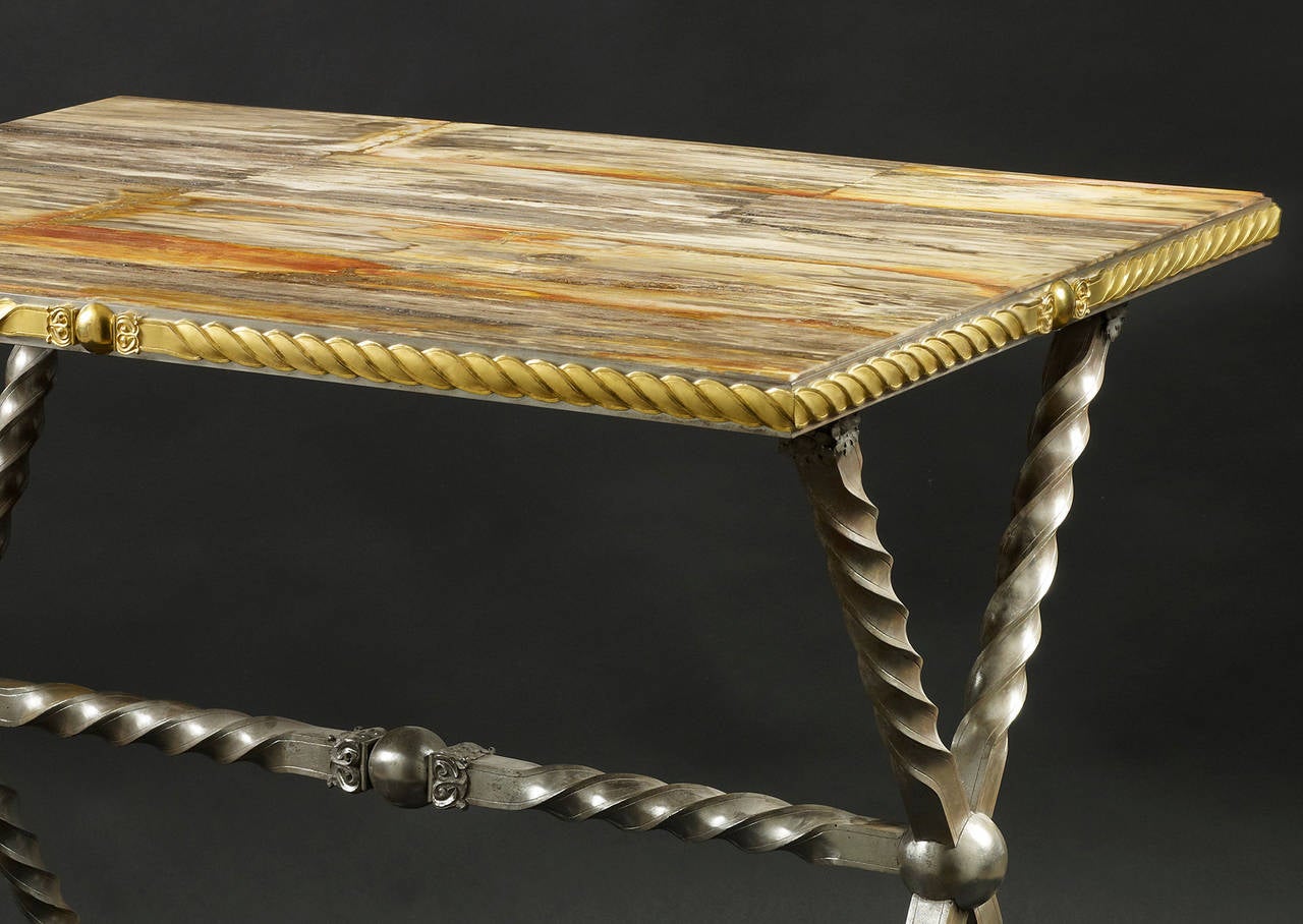 Wrought iron table,
consulat, circa 1800
fossilized wood marble like with a gilded bronze belt around the top
Dimensions: W 41 in X D 29.5 in x H 36 in.

This table recalls the folding campaign tables under Napoleonic times, where army officers