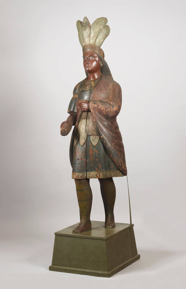 Carved and painted Indian tobacconist figure.
Attributed to Samuel Robb (1851-­1928), New York,
on its original base.
These figures were placed outside the stores to indicate to the clients that tobacco was for sale inside.
Samuel Robb often