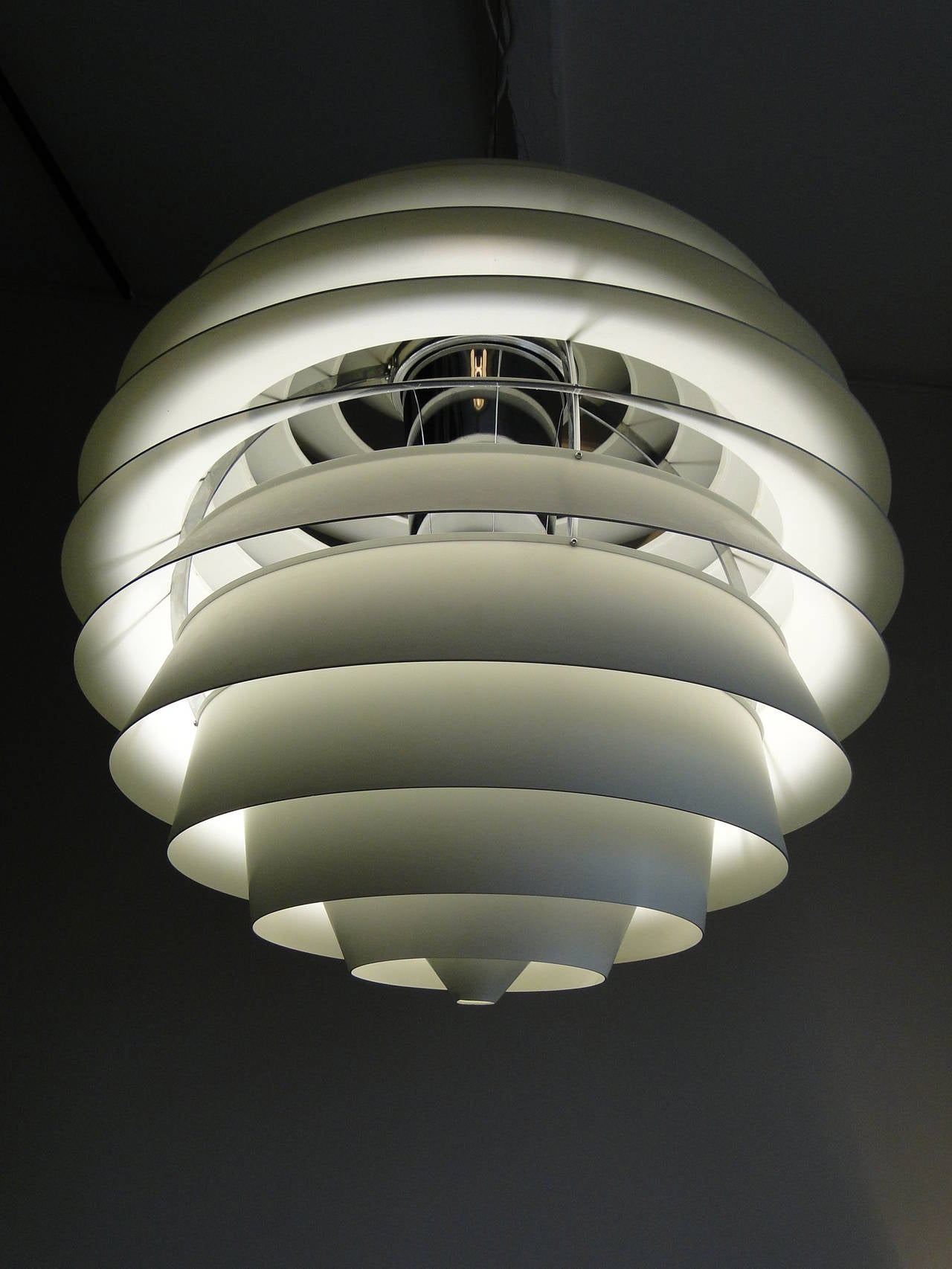 It is a stunning light designed by Poul Henningsen in 1957 for the Adventist Church in Skodsborg, Denmark. Clever stuff too - the PH Ball is a glare-free light, with all 13 colors (mounted on 4 legs) to provide light at the exact same angle and