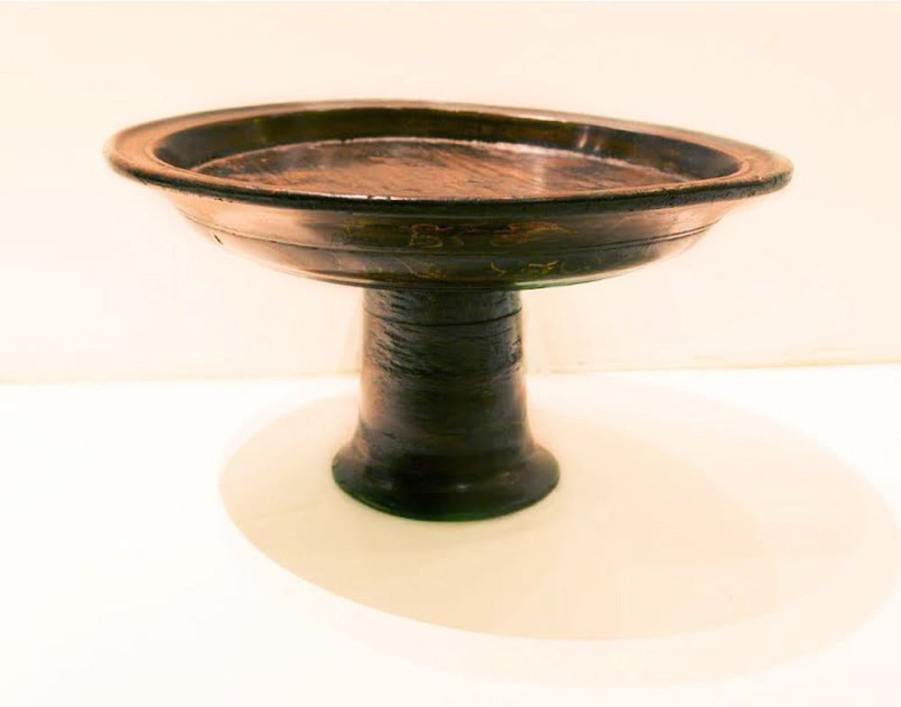 Dulang bowl, hand-carved from a single piece of wood, slightly worn from use and age. Used during ceremonies, with an arrangement of towering fruit as offering.