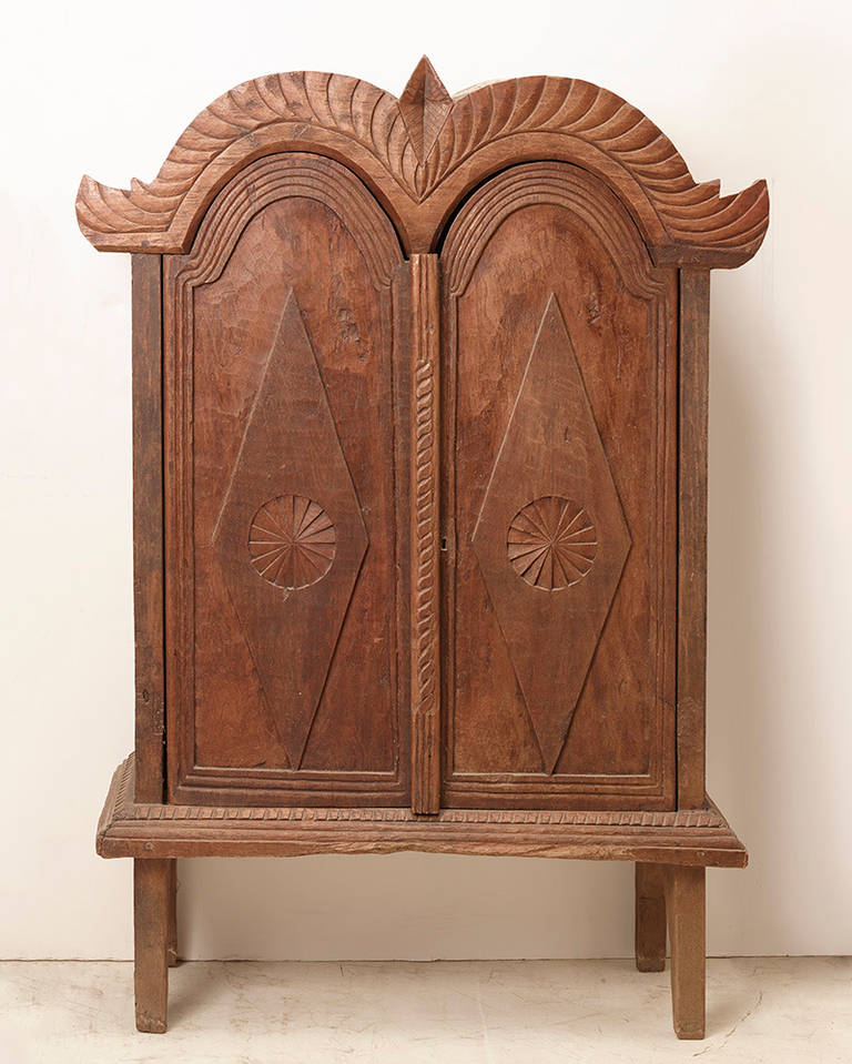 Fine hand carved Indonesian colonial era cabinet in an excellent shape, carved out of large planks of teak wood, with beautiful patina.