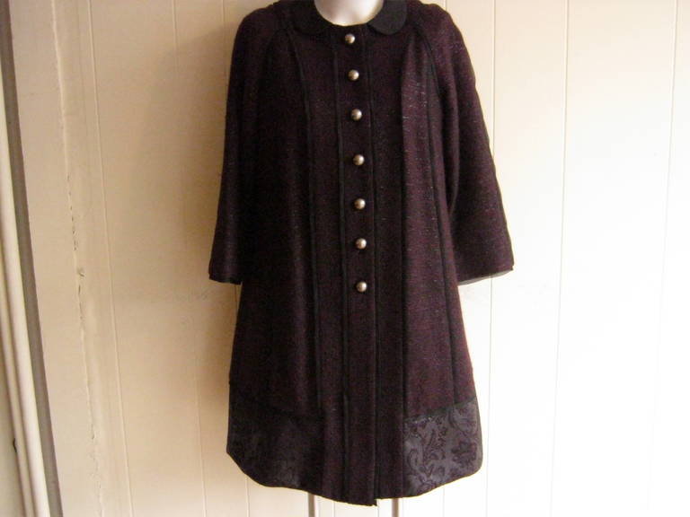 This fabulous suit can be worn together or separately. The coat has seven matte silver round buttons down the front and a wide lace hemline. The jacket has a grosgrain fold over the collar, cuff and down the coat, the trim is silk with burgundy with