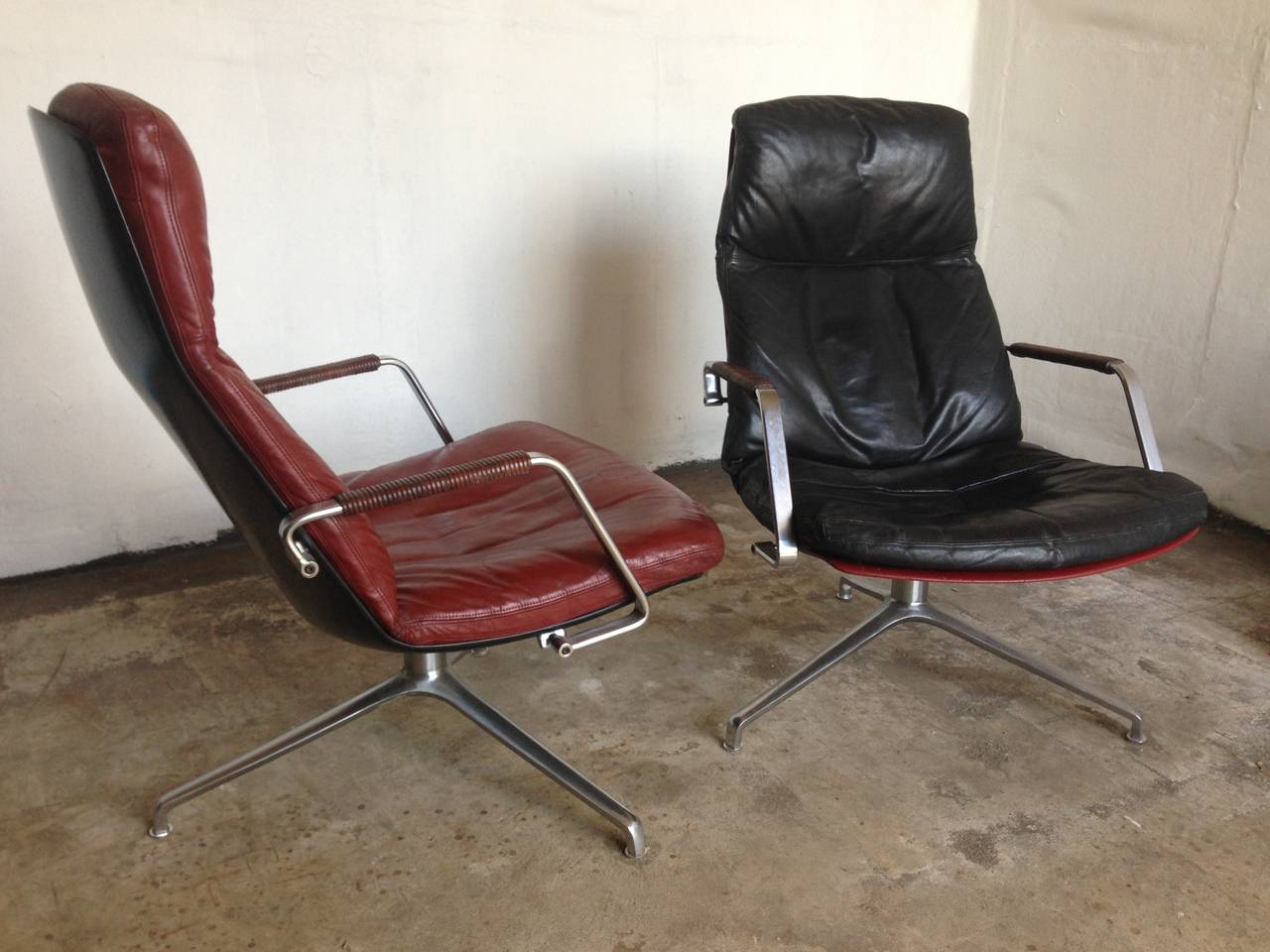 2x Preben Fabricius Jorgen Kastholm lounge chairs
Produced by Kill international 1965
These two are first editions with polyester shell back ,one in red and the other in black
Leather sitting cushions
metal armrest covered with leather