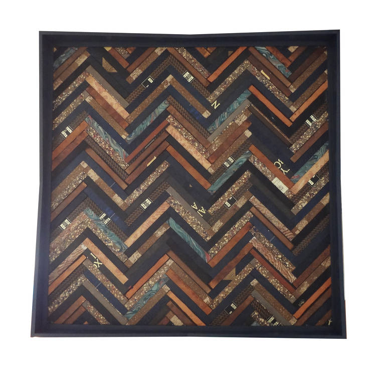 This rectangular tray is a study in sartorially inspired design, thanks to its herringbone pattern. Navy and brown are flecked with ecru and sand, for a rich, handsome appeal. Perfect for entertaining or to organize a desk. Book cover surfaces are