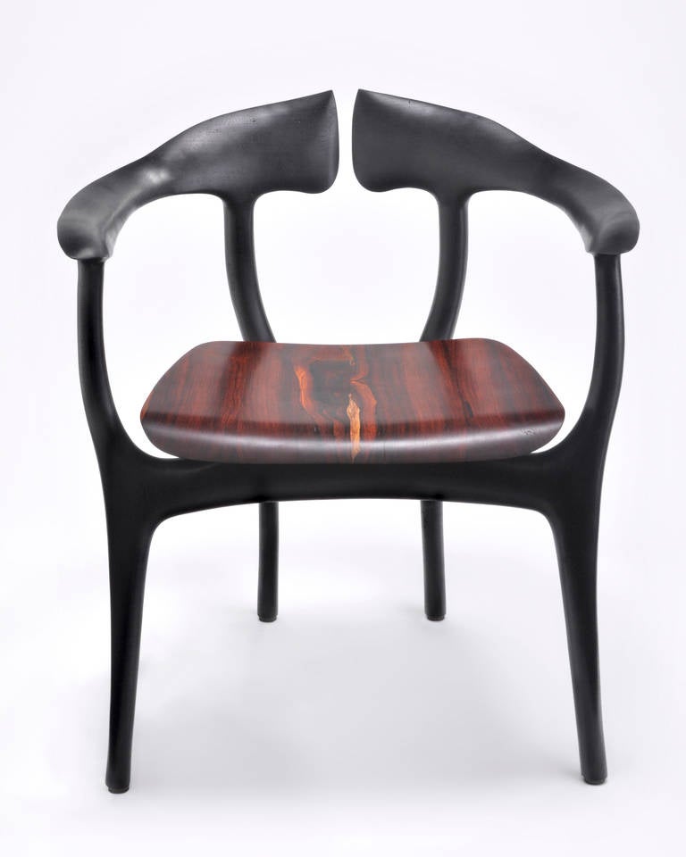 This stunning chair is subtly reminiscent of a swallowtail butterfly with its deeply forked back resembling a winged tail, and rounded curved sides that help anchor the wide set front legs. As comfortable as it is beautiful, this is the perfect