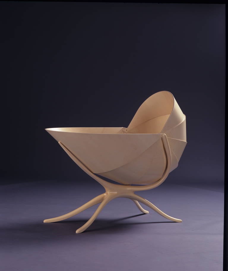 Miller reimagines the traditional crib and creates an oasis of tranquility and ultimate comfort for an infant. The soft curves of the conch-like cradle, crafted from laminated sycamore, transform furniture into art, making this piece a striking