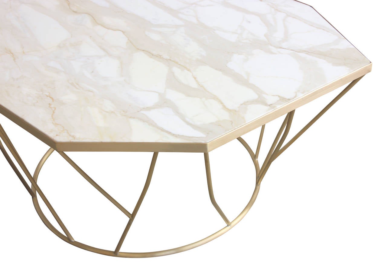 A glamorous cocktail table with retro influence. Branch-like tendrils of hand-welded brushed bronze create a geometric base that artfully supports a gleaming slab of Calcutta gold marble. 

We specialize in custom commissions.
Custom materials,